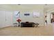 Well-lit living room featuring tile floors, neutral walls, and tasteful decor with art at 9020 Eagle Bay Ct, North Port, FL 34287