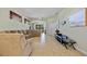 Spacious living room with plush seating, tile floors, and an open layout to the kitchen area at 9020 Eagle Bay Ct, North Port, FL 34287