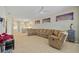 Open-concept living room flowing into the kitchen, featuring a large sectional sofa and neutral decor at 9020 Eagle Bay Ct, North Port, FL 34287