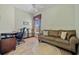 Cozy living room with a comfortable sofa, wooden floors, and a window with stylish curtains at 9020 Eagle Bay Ct, North Port, FL 34287