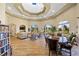 Spacious lounge with comfortable seating, wood floors, and bright natural light from large windows at 9020 Eagle Bay Ct, North Port, FL 34287