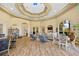 Open lounge area with cozy furniture, wood-look floors, and access to outdoors at 9020 Eagle Bay Ct, North Port, FL 34287