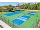 Well-maintained community tennis and pickleball courts with lush green surroundings at 9020 Eagle Bay Ct, North Port, FL 34287