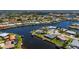 Waterfront home featuring a serene canal, boat dock, lush landscaping, and an inviting outdoor living space at 1206 Winward Ct, Punta Gorda, FL 33950