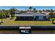 Back exterior view of home with a private dock and screened porch overlooking the water at 1206 Winward Ct, Punta Gorda, FL 33950