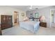 Comfortable bedroom featuring a queen bed, side tables, and a view into the ensuite bathroom at 1206 Winward Ct, Punta Gorda, FL 33950
