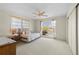 Bedroom with a ceiling fan, view of the canal, daybed, and white carpet at 1206 Winward Ct, Punta Gorda, FL 33950
