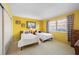 Bright bedroom features twin beds, yellow walls, closet, and natural light at 1206 Winward Ct, Punta Gorda, FL 33950