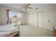 Bedroom features a waterfront view, ceiling fan, white carpet, and closet at 1206 Winward Ct, Punta Gorda, FL 33950