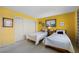 Bright bedroom features twin beds, yellow walls, closet, and natural light at 1206 Winward Ct, Punta Gorda, FL 33950