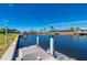 Waterfront dock with boat, providing easy access to the canal and open waters for boating at 1206 Winward Ct, Punta Gorda, FL 33950