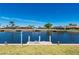 Private boat dock on the canal, perfect for boating and enjoying waterfront living with scenic views at 1206 Winward Ct, Punta Gorda, FL 33950