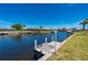 Tranquil view of a private boat dock on a canal, perfect for boating enthusiasts at 1206 Winward Ct, Punta Gorda, FL 33950
