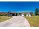 Single-story home featuring a tile roof and circular driveway surrounded by a well-maintained lawn and mature landscaping at 1206 Winward Ct, Punta Gorda, FL 33950