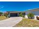 Single-story home featuring a tile roof and circular driveway surrounded by a well-maintained lawn and mature landscaping at 1206 Winward Ct, Punta Gorda, FL 33950