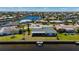 Waterfront home with backyard dock access, a screened lanai, and tropical landscaping at 1206 Winward Ct, Punta Gorda, FL 33950