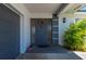 Front door featuring a wreath decor and tropical landscaping near garage entrance at 1206 Winward Ct, Punta Gorda, FL 33950