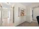 Well-lit hallway featuring an open shuttered pass-through and neutral wall paint, complete with access to multiple rooms at 1206 Winward Ct, Punta Gorda, FL 33950