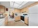 The bright kitchen features light cabinets, ample counter space, and is open to the adjacent dining room at 1206 Winward Ct, Punta Gorda, FL 33950