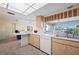 Bright kitchen featuring a breakfast bar, plenty of counter space, and views of the backyard at 1206 Winward Ct, Punta Gorda, FL 33950