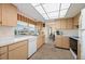 The efficient kitchen has a window over the sink looking out to the backyard and an open view to the dining room at 1206 Winward Ct, Punta Gorda, FL 33950
