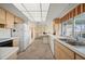 A functional kitchen with bright cabinets, an efficient layout, and views of the backyard from the window at 1206 Winward Ct, Punta Gorda, FL 33950