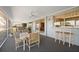 Enclosed lanai with water view, ceiling fan, bar seating, and dining table at 1206 Winward Ct, Punta Gorda, FL 33950