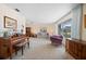 Sunlit living room with piano, artwork and bright natural light at 1206 Winward Ct, Punta Gorda, FL 33950