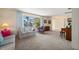 The living room features large windows, comfortable seating, and easy access to other rooms in the house at 1206 Winward Ct, Punta Gorda, FL 33950