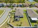 Aerial view of home with fenced-in yard, screened patio with dining set, and well-manicured lawn at 15288 Mille Fiore Blvd, Port Charlotte, FL 33953
