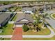 Aerial view of home showcasing its brick driveway, manicured lawn, landscaping, and fenced backyard at 15288 Mille Fiore Blvd, Port Charlotte, FL 33953