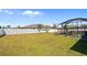 Expansive backyard with a screened-in lanai, a white privacy fence, and mature landscaping at 15288 Mille Fiore Blvd, Port Charlotte, FL 33953