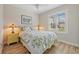 Comfortable bedroom featuring a ceiling fan, a large window and wood flooring at 15288 Mille Fiore Blvd, Port Charlotte, FL 33953