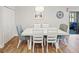 Elegant dining room featuring a white table, stylish chairs, and modern light fixture at 15288 Mille Fiore Blvd, Port Charlotte, FL 33953