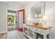 Inviting entryway featuring decorative console table with decor, and a red door leading to the outside at 15288 Mille Fiore Blvd, Port Charlotte, FL 33953