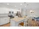 Bright open kitchen with stainless appliances, granite countertops and an island with counter seating at 15288 Mille Fiore Blvd, Port Charlotte, FL 33953