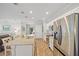 Modern kitchen with stainless steel appliances, granite countertops, and a spacious island with seating at 15288 Mille Fiore Blvd, Port Charlotte, FL 33953