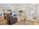 Relaxing living room with tile floors, ceiling fans, and comfortable seating, with abundant natural light at 15288 Mille Fiore Blvd, Port Charlotte, FL 33953