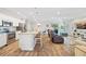 Bright, open-concept living area with stainless steel appliances, a kitchen island, and comfortable seating at 15288 Mille Fiore Blvd, Port Charlotte, FL 33953