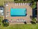 Aerial view of a refreshing community pool with ample seating and meticulously maintained brick paved deck at 15288 Mille Fiore Blvd, Port Charlotte, FL 33953