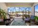 Cozy screened patio featuring comfortable seating, an outdoor rug, and views of the fenced backyard at 15288 Mille Fiore Blvd, Port Charlotte, FL 33953