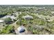 Aerial view of country home surrounded by green landscape and neighboring properties at 16180 Forest Glen Ct, Punta Gorda, FL 33982