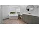 Bathroom with large tub under window and vanity with stool at 16180 Forest Glen Ct, Punta Gorda, FL 33982
