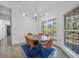 Cozy dining room with a modern light fixture, a wood table, and bright windows at 16180 Forest Glen Ct, Punta Gorda, FL 33982