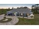 A well-kept single-story home with a metal roof, circular driveway, and charming front porch details at 16180 Forest Glen Ct, Punta Gorda, FL 33982