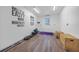 Modern home gym boasts motivational wall art, durable wood flooring, and abundant natural light at 16180 Forest Glen Ct, Punta Gorda, FL 33982