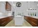 Open kitchen featuring a large island, modern lighting, and stainless steel appliances at 16180 Forest Glen Ct, Punta Gorda, FL 33982