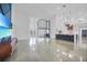 Spacious open-concept living area showcasing a stylish kitchen, and floor-to-ceiling glass enclosed room at 16180 Forest Glen Ct, Punta Gorda, FL 33982
