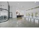Spacious living area with high ceilings, a kitchen island with bar seating, and floor to ceiling glass paneled walls at 16180 Forest Glen Ct, Punta Gorda, FL 33982