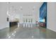 Bright open-concept living space with modern finishes, a sleek kitchen island, and unique architectural details at 16180 Forest Glen Ct, Punta Gorda, FL 33982